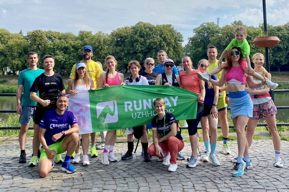 Community run group with banner by the river